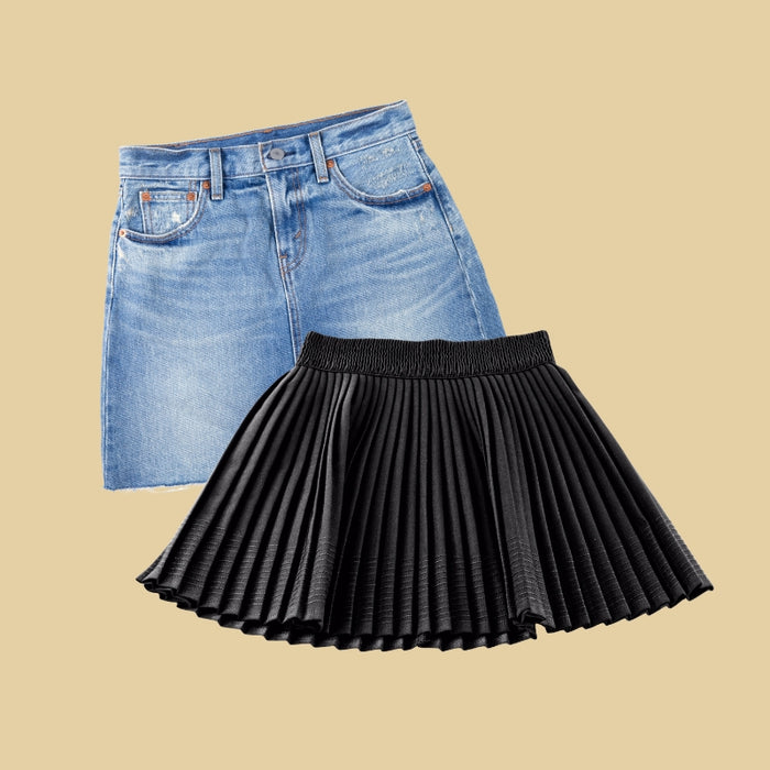Blue denim skirt and black pleated skirt on a beige background
