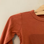 goumi burnt orange bodysuit 6-12M
