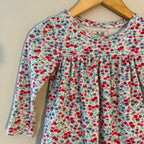 Close-up detail of Baby Gap white long-sleeve top showing ditsy floral print in red purple and pink with gathered yoke for girls 18M