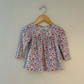 Front view of Baby Gap white ditsy floral cotton long-sleeve top with empire waist gather for girls 18M