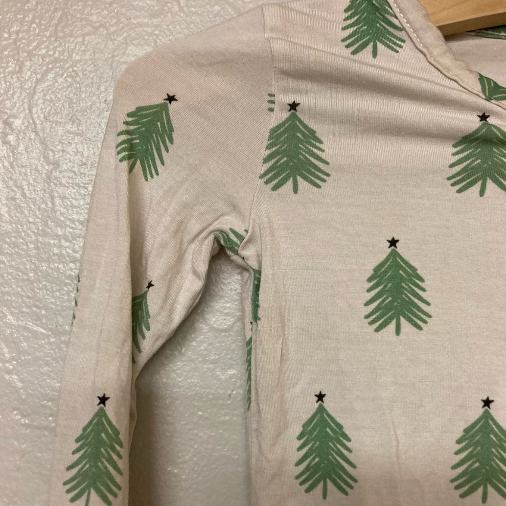 Close-up detail of Forever French Baby tshirt showing pine tree print pattern with star accents
