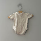 Back view of Goumi x Babylist ivory organic cotton short-sleeve snap bodysuit gender neutral size 6-9M