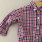 Close-up detail of Janie and Jack boys shirt showing pink navy white gingham pattern and button-front closure