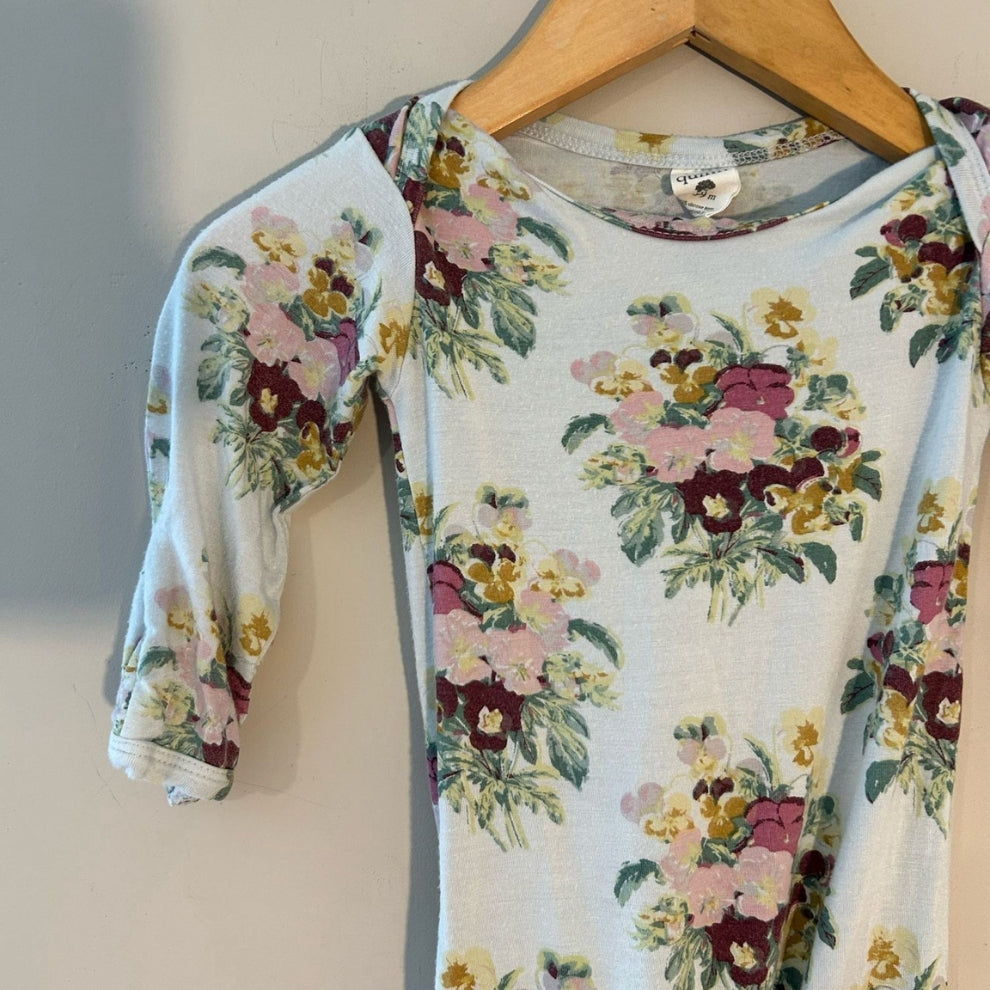 Close-up detail of Kate Quinn light blue bamboo romper showing multicolor vintage floral bouquet pattern and soft knit fabric size 6-9 months