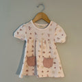 Organic cotton cream dress with bird and rainbow print, short sleeves and front pockets by Kit + Pearl