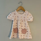Organic cotton cream dress with bird and rainbow print, short sleeves and front pockets by Kit + Pearl
