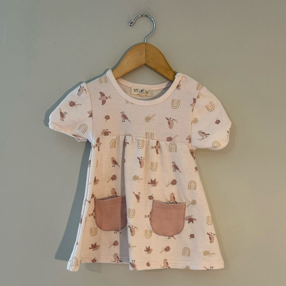 Organic cotton cream dress with bird and rainbow print, short sleeves and front pockets by Kit + Pearl