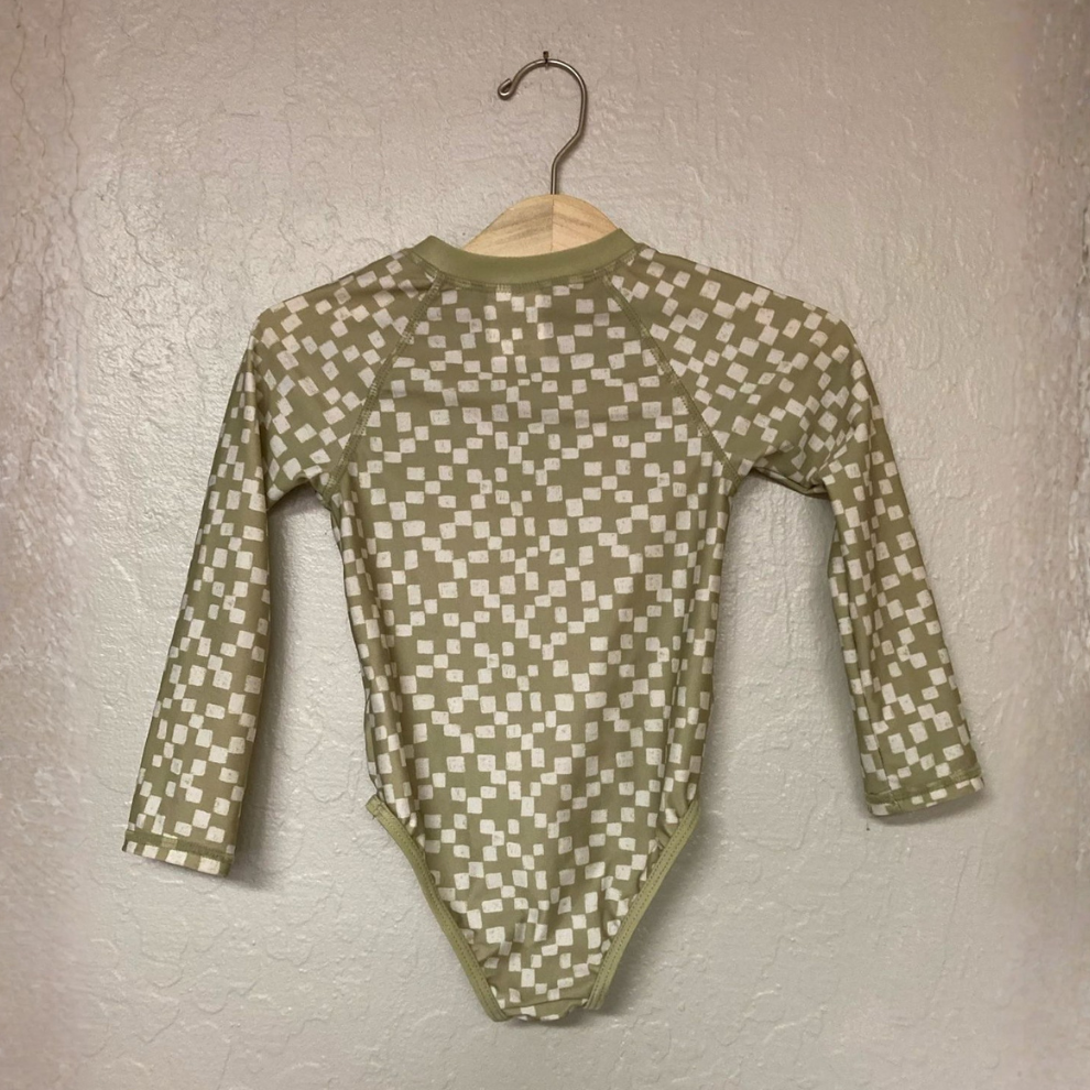 Back view of Little Co. green and white checkered long-sleeve rashguard swimsuit for girls