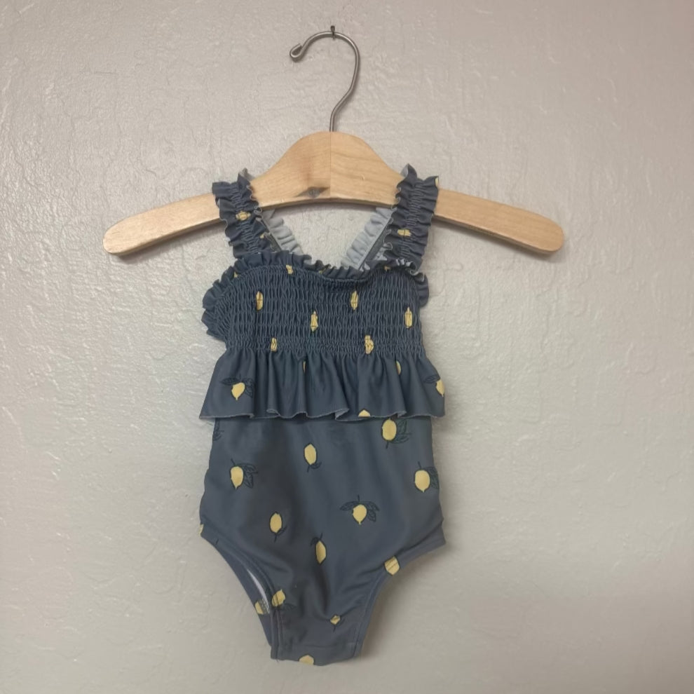 Front view of Modern Moments gray swimsuit with yellow lemon print and smocked ruffle top for girls 6-9 months