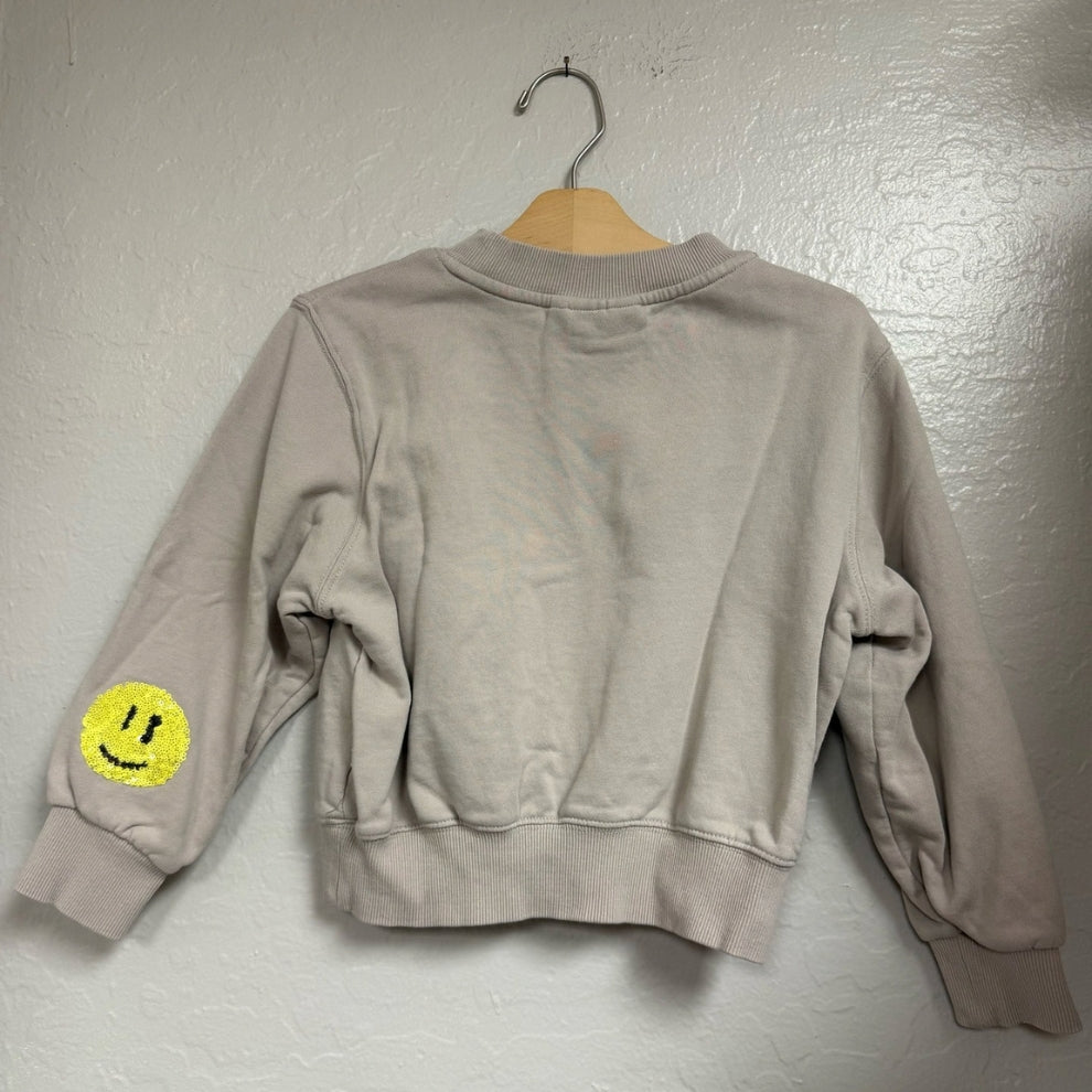 Back view of a Molo light gray crewneck girls’ sweatshirt, size 6Y (EU 116), showing ribbed collar, cuffs, and hem.
