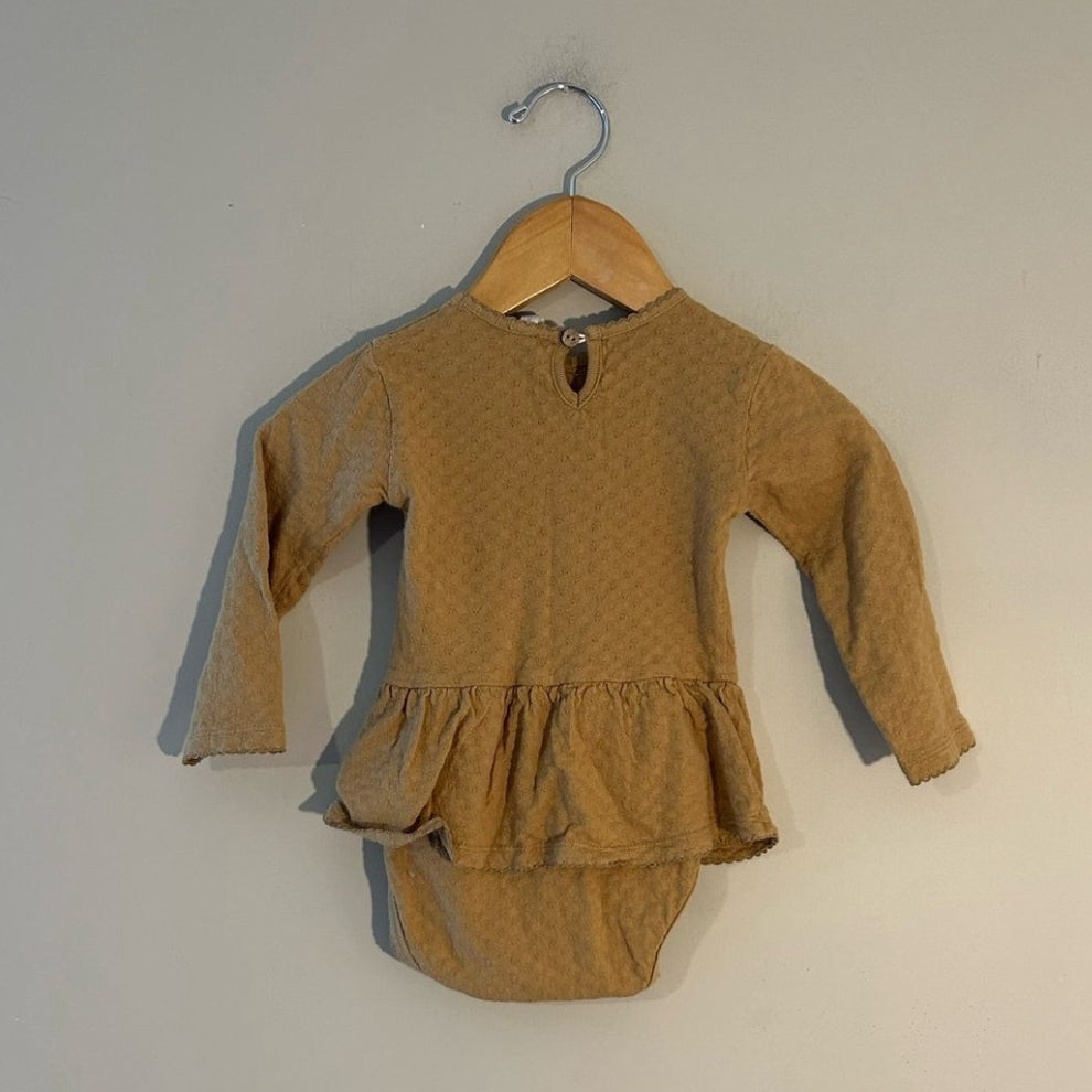Back view of Quincy Mae gold pointelle long-sleeve skirted romper with snap closure for girls
