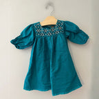 Front view of Tea Collection jade teal green dress with geometric embroidered yoke and puff sleeves for girls 12-18 months