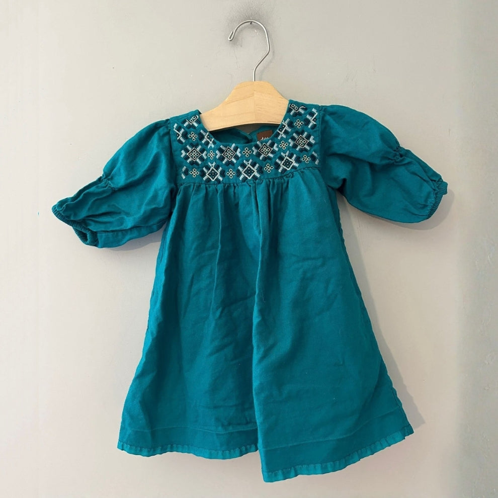 Front view of Tea Collection jade teal green dress with geometric embroidered yoke and puff sleeves for girls 12-18 months