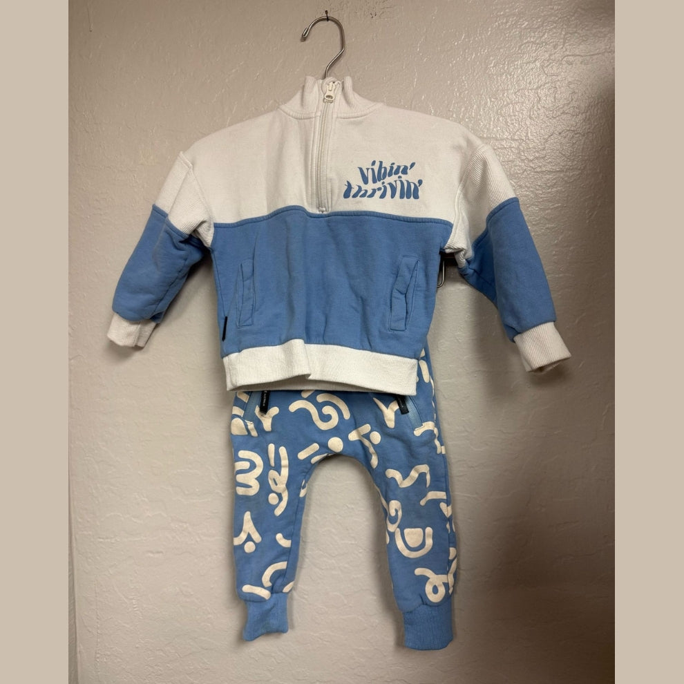 Front view of Tiny Tribe blue and white "Vibin' Thrivin'" color-block zip sweatshirt and blue abstract print jogger set, gender neutral 3Y