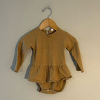 Front view of Quincy Mae mustard gold pointelle skirted romper with ruffled neckline for baby girls