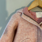 Close-up detail of Zara BabyGirl blush pink wool-blend hooded coat showing soft fabric texture, zip closure, and pink satin lining at collar, size 18-24M