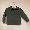 Front view of Zara boys' puffer jacket in charcoal with button closure and zipper pocket detail
