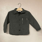 Front view of Zara boys' puffer jacket in charcoal with button closure and zipper pocket detail