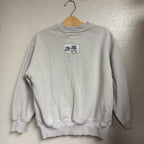 Back view of a Zara light gray crewneck girls’ sweatshirt, size 8–9 years, showing ribbed collar, cuffs, and hem.