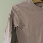 Close-up detail of Zara purple long-sleeve tee showing gathered puff sleeve design