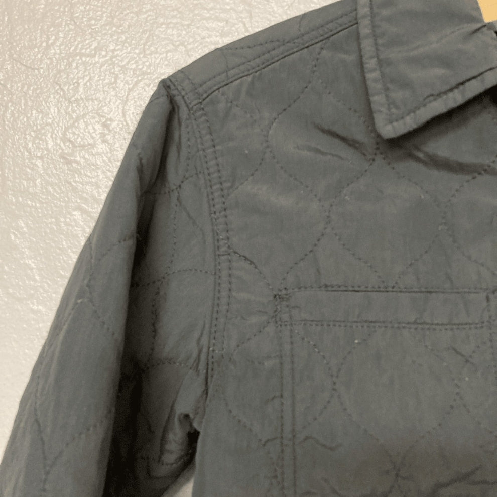 Side detail of Zara charcoal quilted puffer jacket showing stitching pattern and sleeve