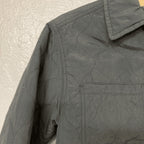 Side detail of Zara charcoal quilted puffer jacket showing stitching pattern and sleeve