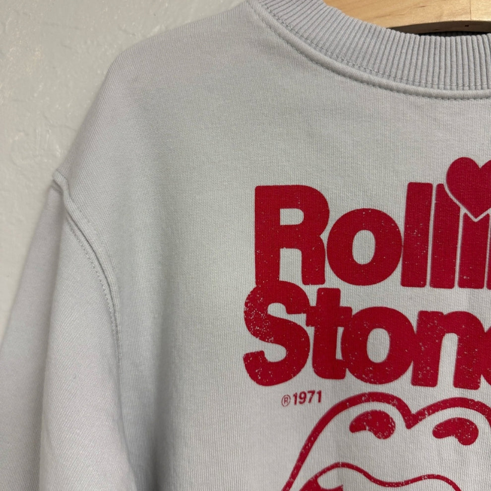 Close-up of the red Rolling Stones logo print on a Zara light gray girls’ sweatshirt in size 8–9 years.