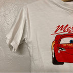 Close-up of Zara white t-shirt featuring Lightning McQueen Cars character graphic detail