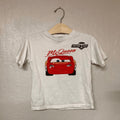 Front view of Zara white short-sleeve t-shirt with Lightning McQueen Piston Cup graphic for toddler boys